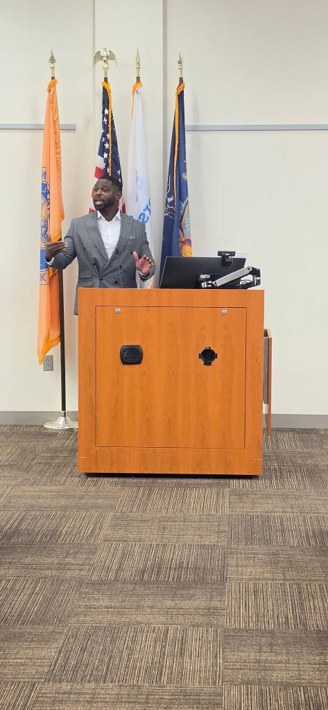 Speaker addressing an audience from a podium.